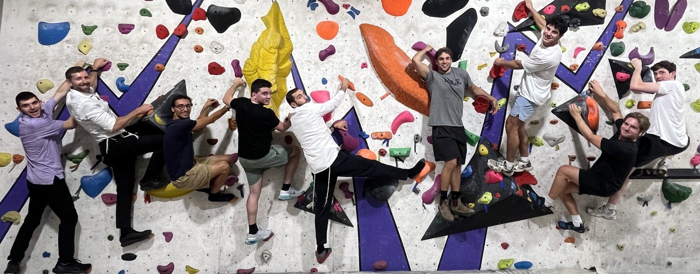 Students climbing at an indoor rock wall